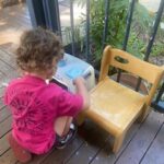 Tadpole students learning to write by scrubbing a chair